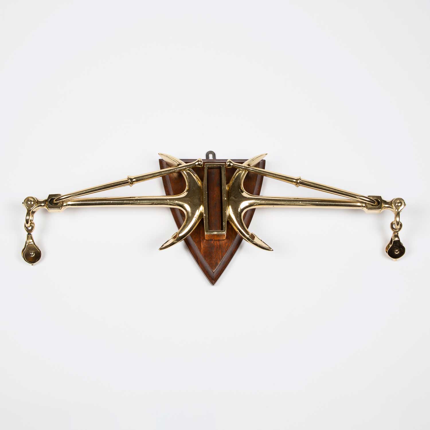 Wall mounted brass tiller yoke of opposed Kedge anchors